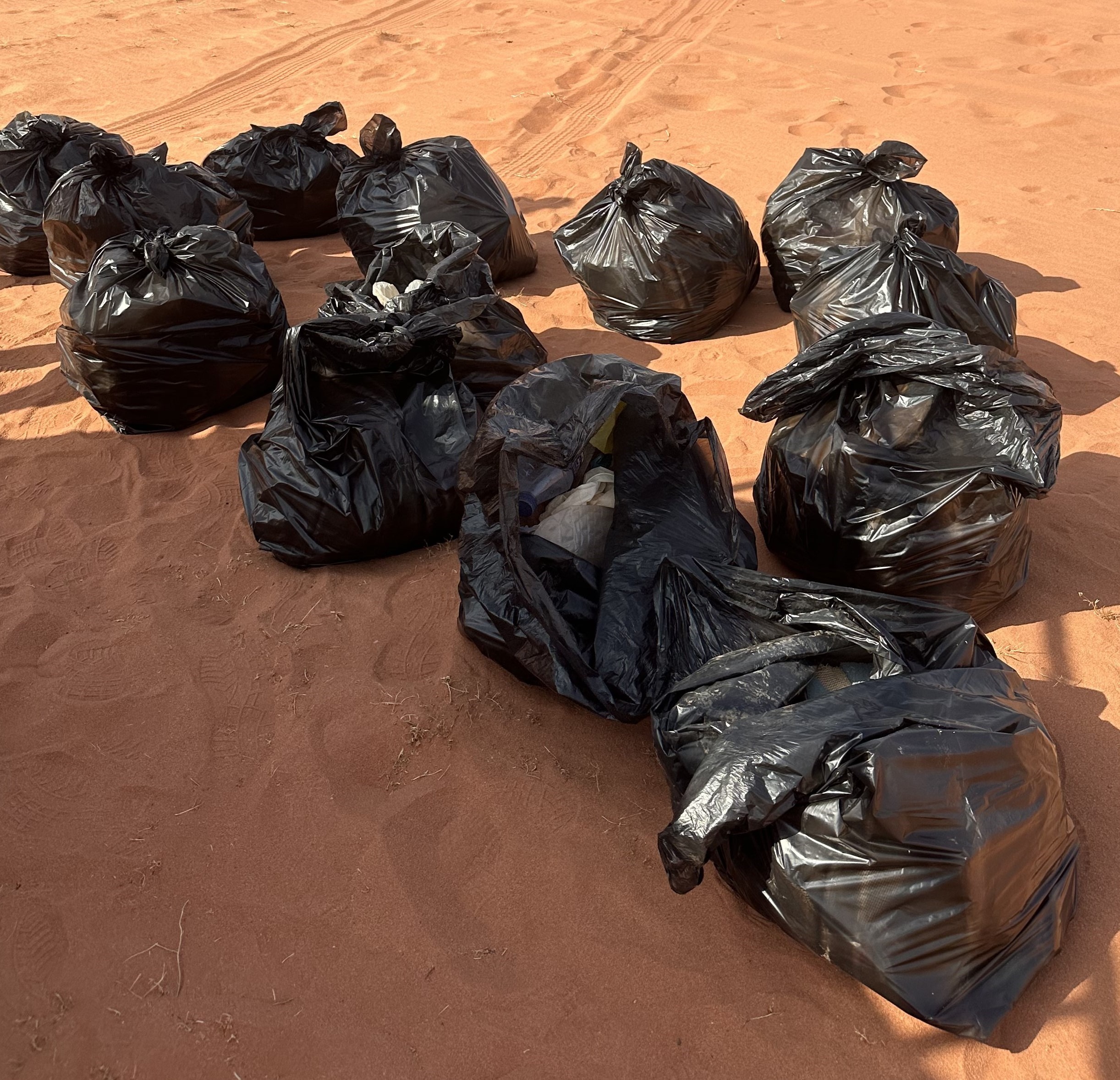 trash bags full of waste from the pick-up action at the Wadi Rum desert